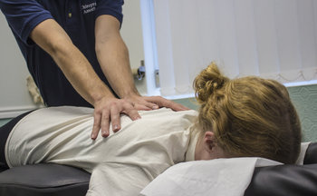 Preston chiropractor Jon Shurr providing treatment for female patient at Chiropractic Associates